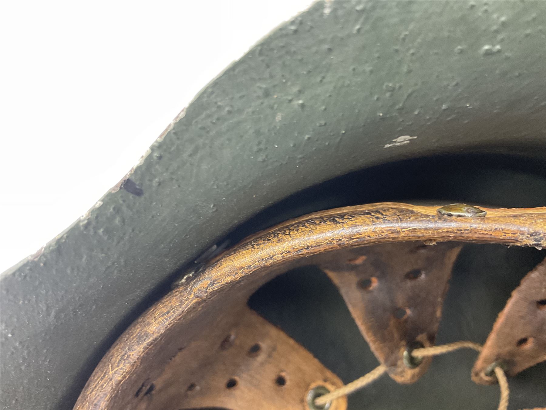 Fully restored German steel helmet, the camouflage painted exterior with two decals and replacement leather liner
