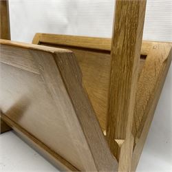 Mouseman - oak magazine rack, the top rail pierced with handle and carved with mouse signature, octagonal supports with two panelled and splayed sides, on sledge feet, by the workshop of Robert Thompson, Kilburn 