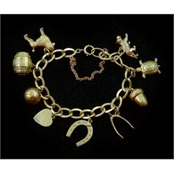 Gold link bracelet, with nine gold charms including poodle, barrel, lion, turtle, horseshoe, ball and acorn, all 9ct hallmarked or tested, approx 19.2gm
