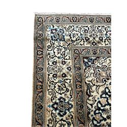 Persian Kashan ivory ground carpet, central rosette medallion surrounded by swirling leafy branches and floral sprays, the main border with scrolling pattern interspersed with floral motifs, within guard stripes 