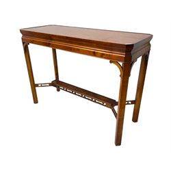 Wade - yew wood console table, rectangular top with canted corners and raised lipped edge, on chamfered square supports united by narrow under-tier