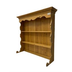 Pine media or television cabinet, enclosed by single glazed door (W56cm, H82cm, D43cm); pine corner cupboard, three shelves over single cupboard (W76cm, H188cm); pine two-tier plate rack with shaped frieze and uprights (W113cm, H107cm)