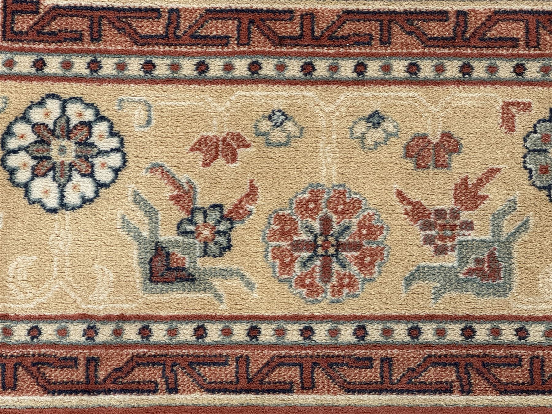 Late 20th century Royal Keshan 'Agra' hand-knotted wool rug, terracotta ground with central floral medallion and scrolling vines, enclosed by a cream border with repeating floral motifs