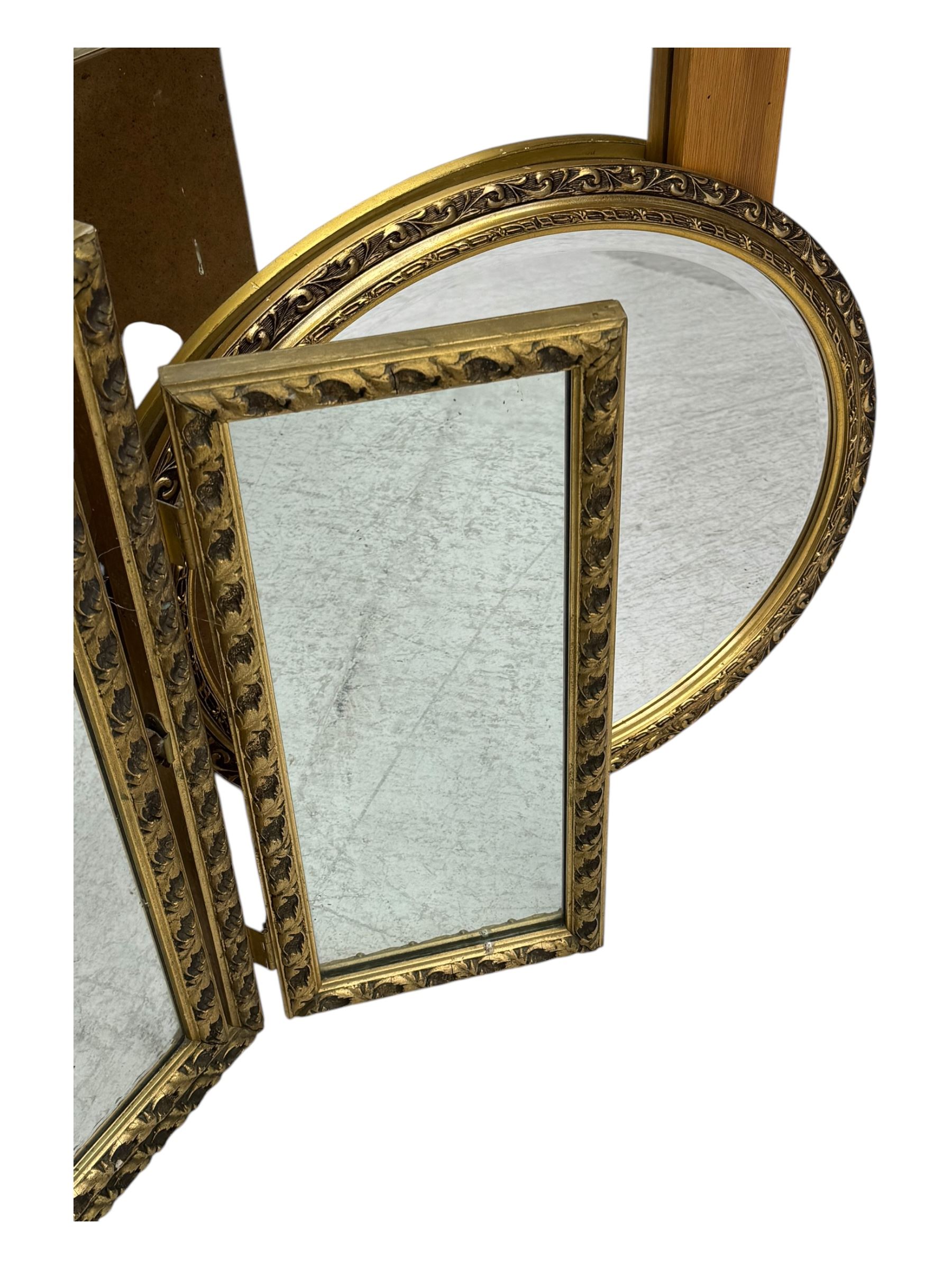 Four decorative mirrors, including gold-toned triptych dressing mirror with foliate borders, two rectangular framed mirrors and a circular gilt mirror with ornate edging