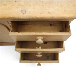Victorian stripped pine sideboard, rectangular plank top rounded edges, with central cupboard door with shaped panel, flanked by two banks of three graduating drawers with turned knobs, raised on a plinth base 