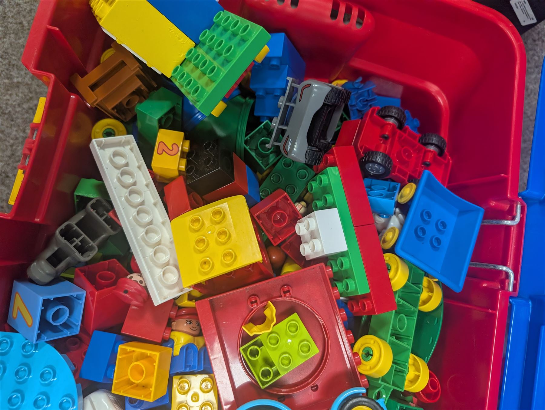 Box of loose Lego Duplo bricks, vehicles and figures