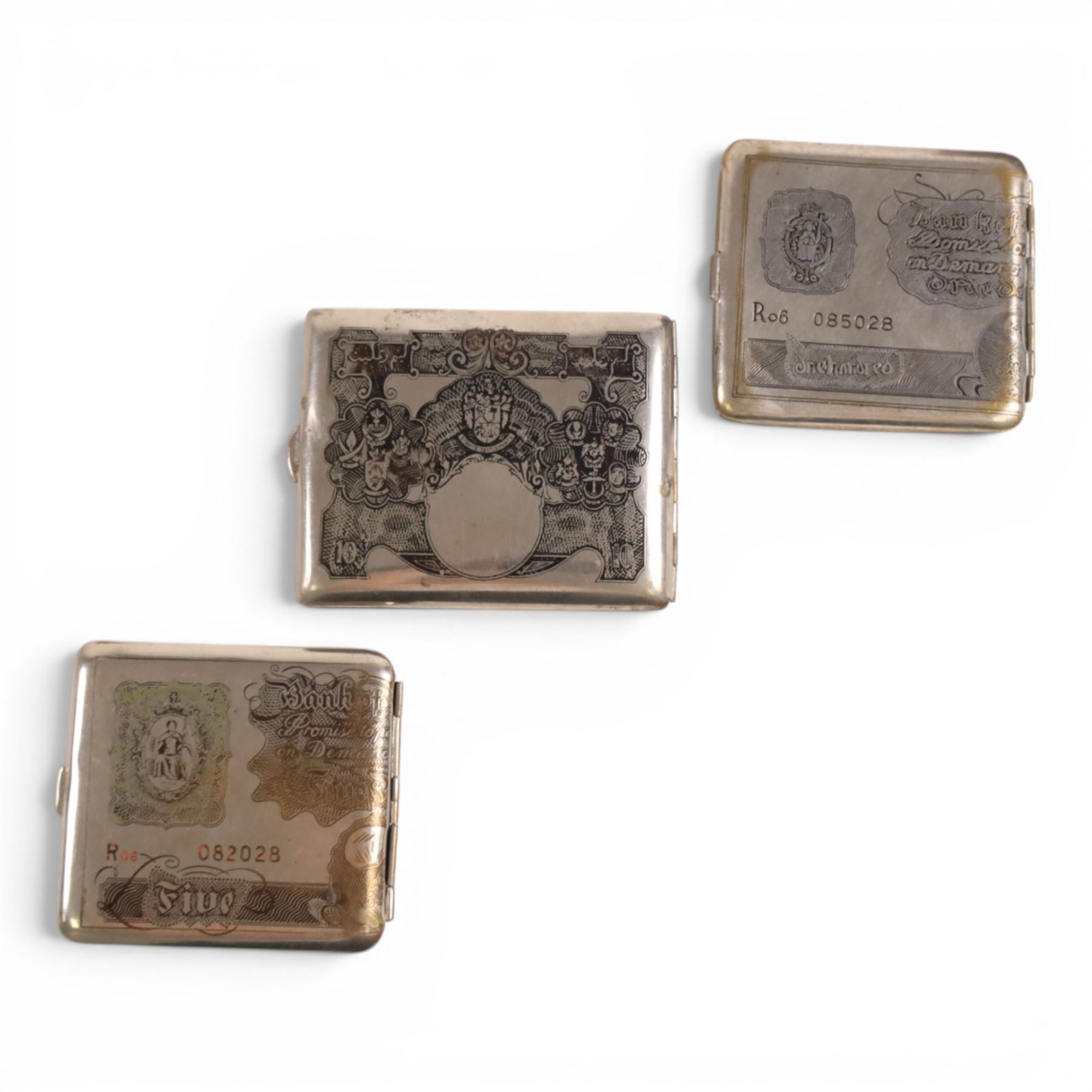 Three cigarette cases, modelled as bank notes, together with a smokers set including ashtray, cigarette case, ligher and cigarette holder, cased and other cigarette holders 
