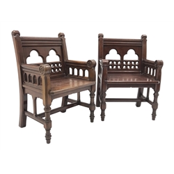  Pair late Victorian oak ecclesiastical armchairs, Gothic style trifoil and pierced back, the arm terminals carved with flower heads, turned front supports connected with H stretcher, with label underneath 'F. Danby's, Leeds', W60cm, seat width - 49cm  
