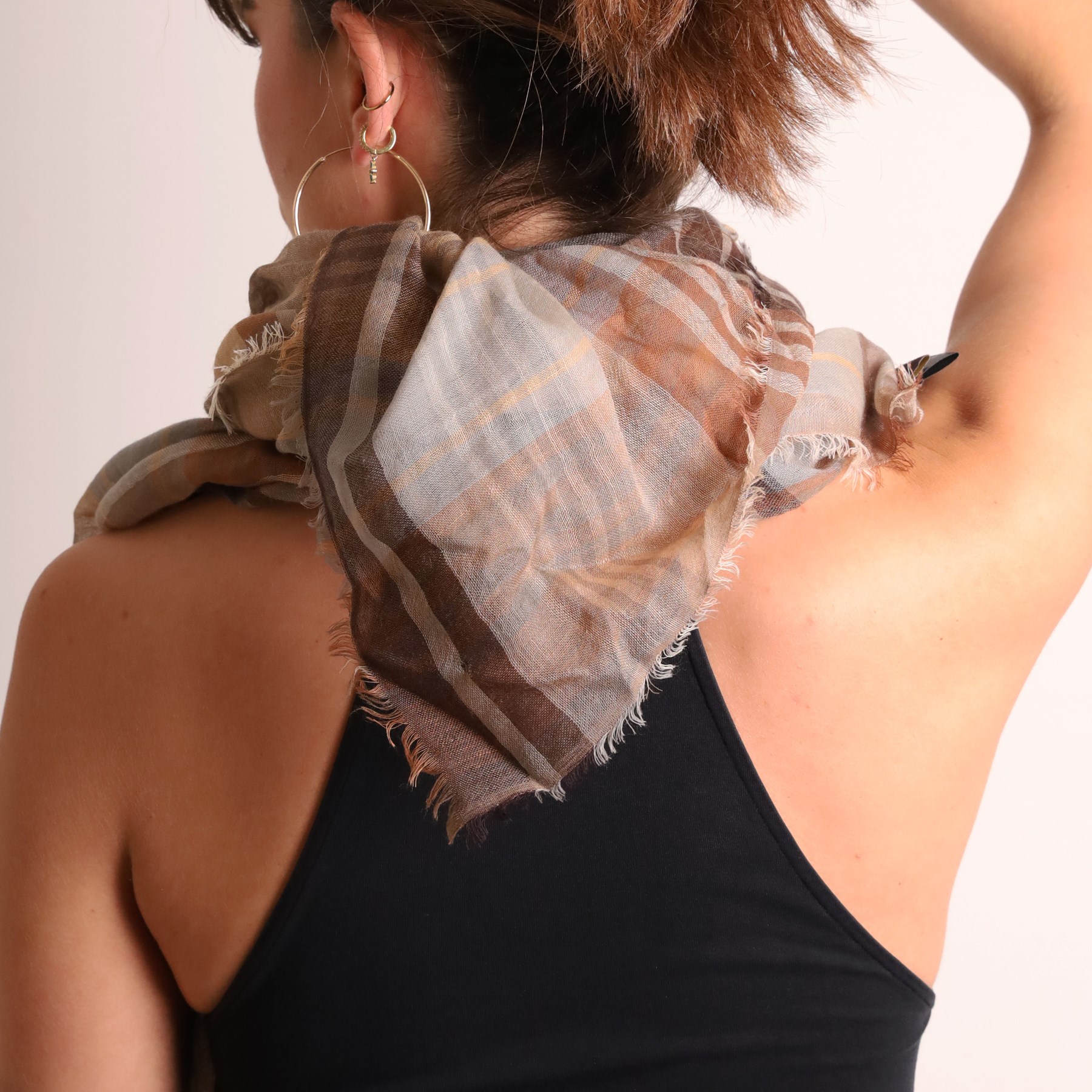 Mulberry - three scarves, comprising grey scarf with repeating tree motif, tan, cream and grey check scarf, and charcoal grey scarf with oversized ‘Mulberry’ motif, all with fringed edges (3)