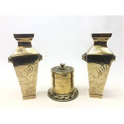  Late 19th century copper tobacco jar with embossed detailing, polished stone handle and lead lined interior with tamper and a pair of Eastern brass tapered square section vases with incised decoration, H23cm (3)  