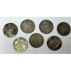 Seven early milled shilling coins, James II date illegible, William III 1696 and another with illegible date, Anne 1705 and two 1711 and George II 1743, varying grades with some heavily worn and bent (7)