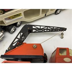 American Nylint large scale tin-plate car transporter L59cm carrying a Testor Toys plastic car; Tonka tin-plate mobile crane; boxed Sarony Cigarettes tin-plate roulette game with rules; and Japanese style tin-plate box, the lid inset with a revolving poker dice game (4)