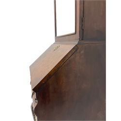 Small early 20th century Queen Anne style bookcase on bureau secretaire, the moulded arched pediment over mirrored door in shaped frame, the bureau fitted with fall front enclosing curved fitted interior, cushion moulded drawer over single drawer, on scroll and shell carved cabriole supports