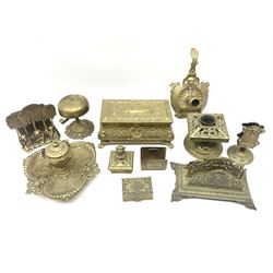 Collection of victorian and later brass desk accessories, to include a letter holder with cherub design, ink well of square form with hinged lid, brass table bell, brass casket with relief decoration, etc  