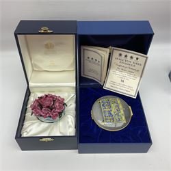 Halcyon Days bonbonniere, modelled as pink roses in a planter painted with a blue and white Japanese scene, together with five Halcyon Days enamel boxes, one a larger example depicting 'The Becket Casket' and four smaller boxes, including The 1993 Easter Egg, Happy Birthday and Statue of Liberty examples, all boxed, Becket Casket D8cm
