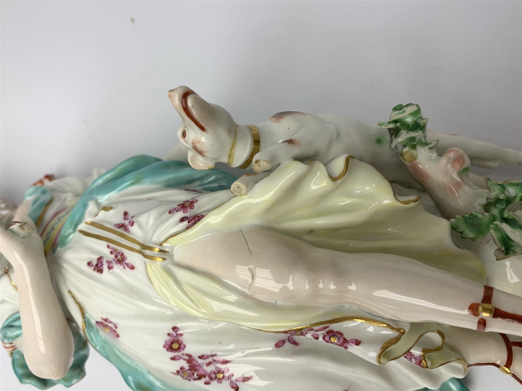 Mid 18th century Derby porcelain figure modelled as Dianna the Huntress, with quiver of arrows upon her back and dog by her side, upon a naturalistically modelled base, with patch marks beneath and collectors labels, H26cm