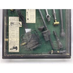 Wall hanging display case containing hunting ephemera to include cartridge boxes, snares, gun cleaning equipment etc