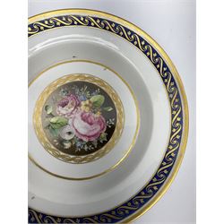 Late 18th/early 19th century German porcelain dish, probably Furstenberg, the centre decorated with a hand painted panel of flowers, within gilt bands and a blue border to rim heightened with gilt scroll, with blue underglaze marks beneath, D23.5cm