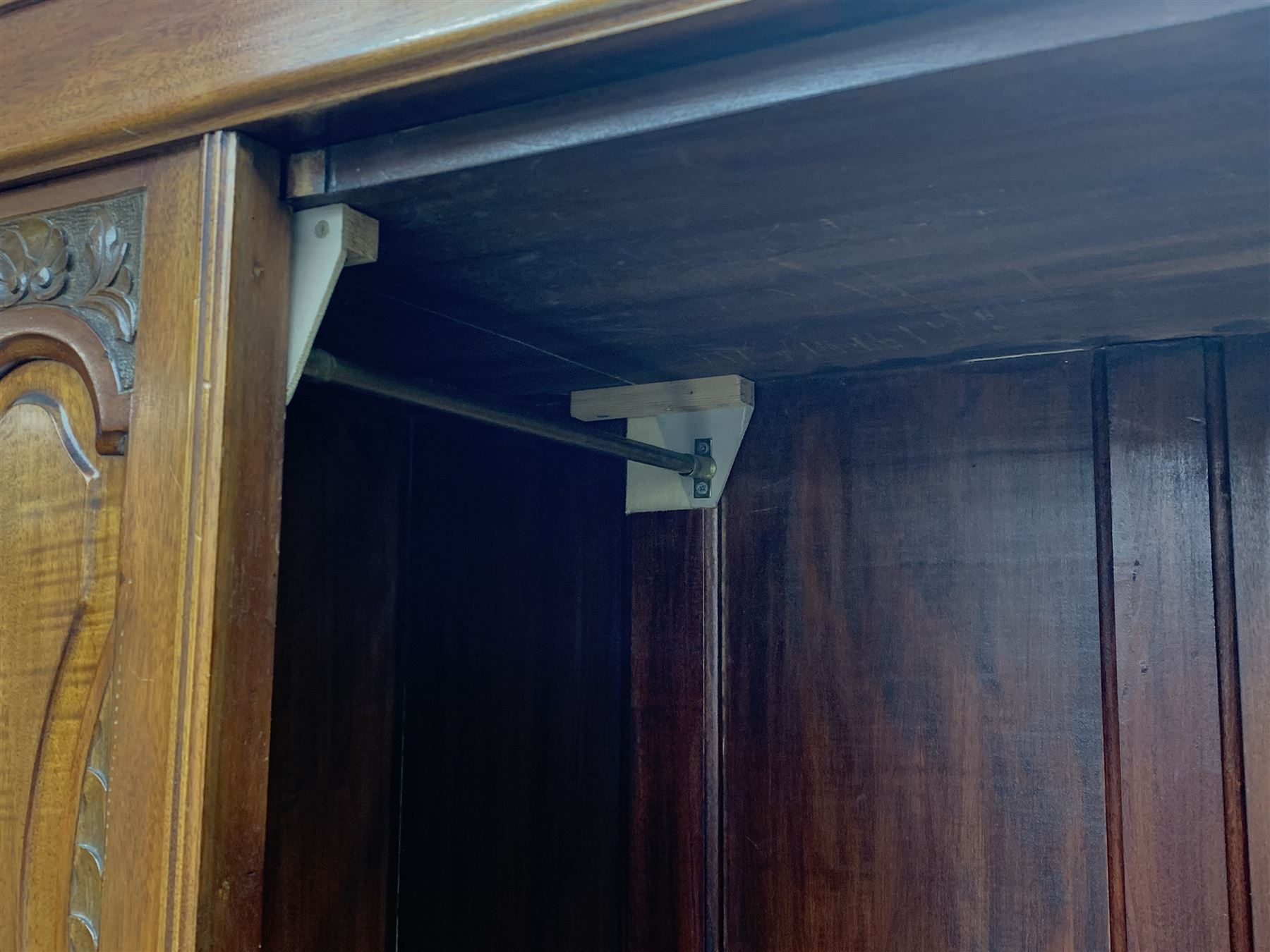 *Edwardian walnut narrow single wardrobe, projecting cornice over single bevelled mirror glazed door, panelled front carved with shells and flower heads, base fitted with single drawer, W90cm, H202cm, D54cm
