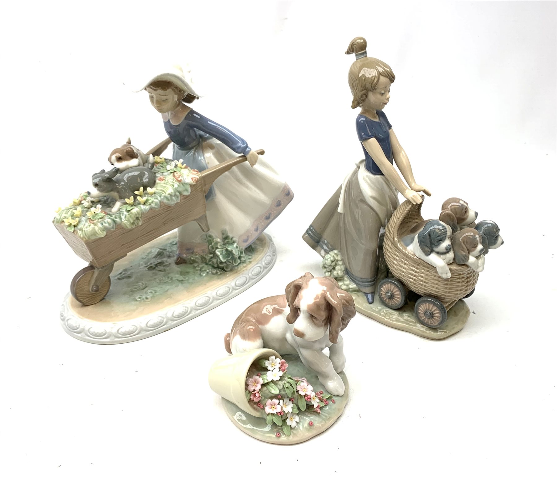 A Lladro figurine, 'Barrow of Fun' Model 5460, H20.5cm, together two further Lladro figurines, 'Litter of Fun' Model 5364, and 'It wasn't me' Model 7672. 