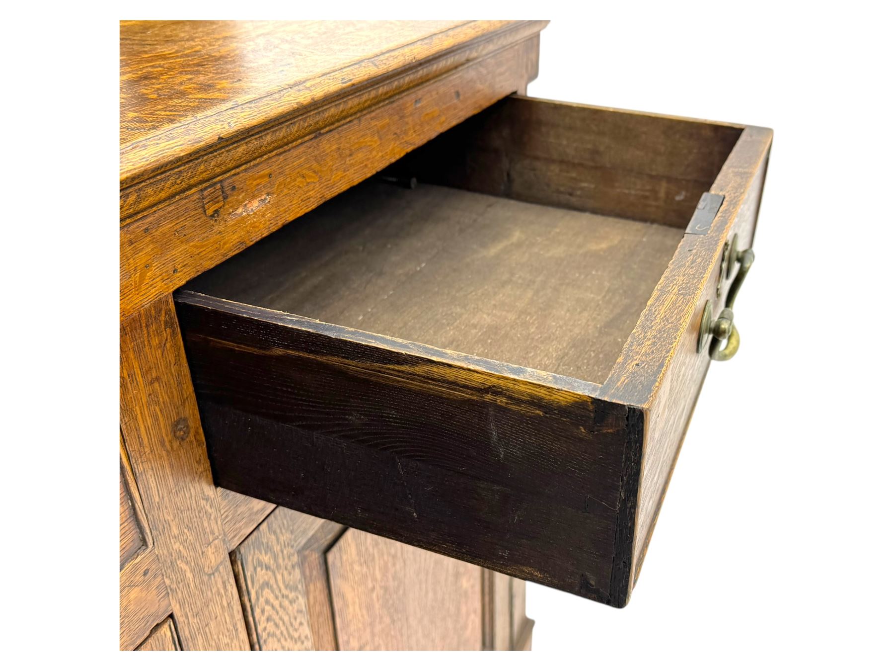 19th century and later oak dresser, moulding cornice a pierced and shaped frieze, over two open plate shelves above a base fitted with two drawers with brass swan neck handles, over panelled twin cupboard with single shelf, cantered corners on bracket feet