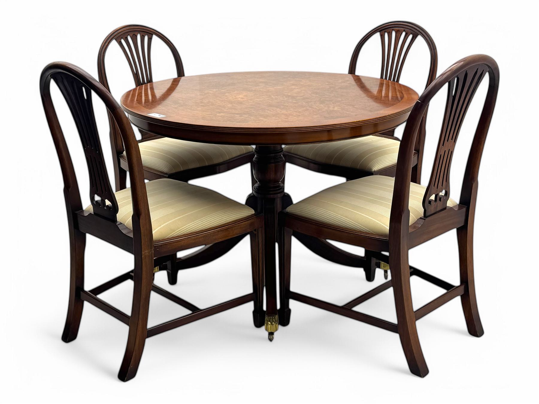 Ian Smith Furniture - Georgian design walnut centre table, the circular banded top with fluted edge, supported by a turned pedestal base with four splayed supports, each terminating in brass castors with claw caps; set of four mahogany dining chairs each with pierced vase-shaped splats and upholstered seats