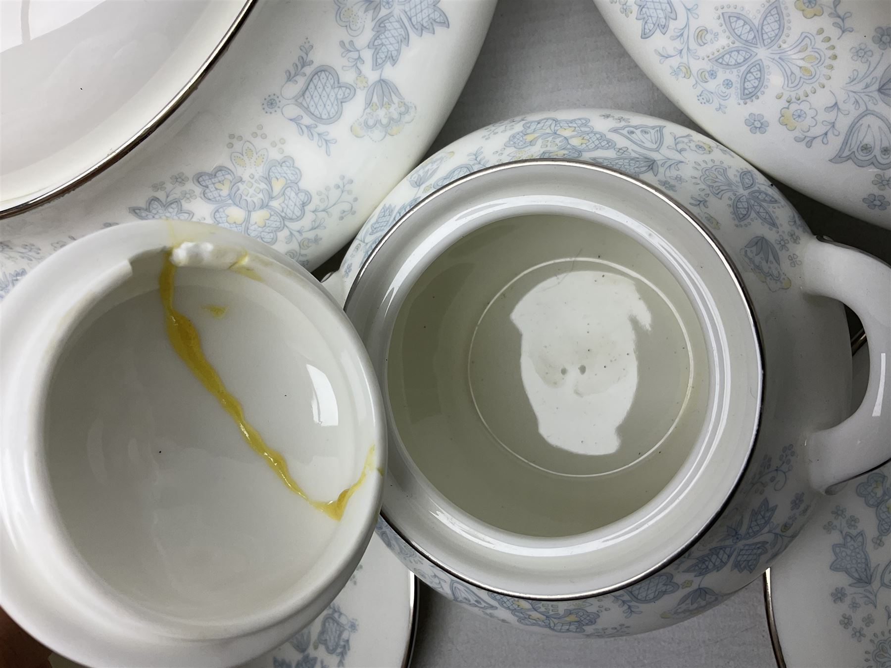 Royal Doulton tea and dinner wares in the Meadow Mist pattern, no H5007, comprising seven dinner plates, eight side plates, two lidded tureens, two jugs, lidded sucrier, oval serving dish, six teacups, seven saucers, seven tea plates and large saucer
