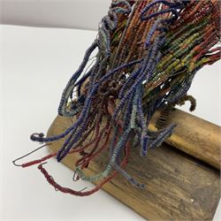 Victorian bead and wire model of a parrot, of polychrome beads, with glass eyes, on a wooden base, H24cm