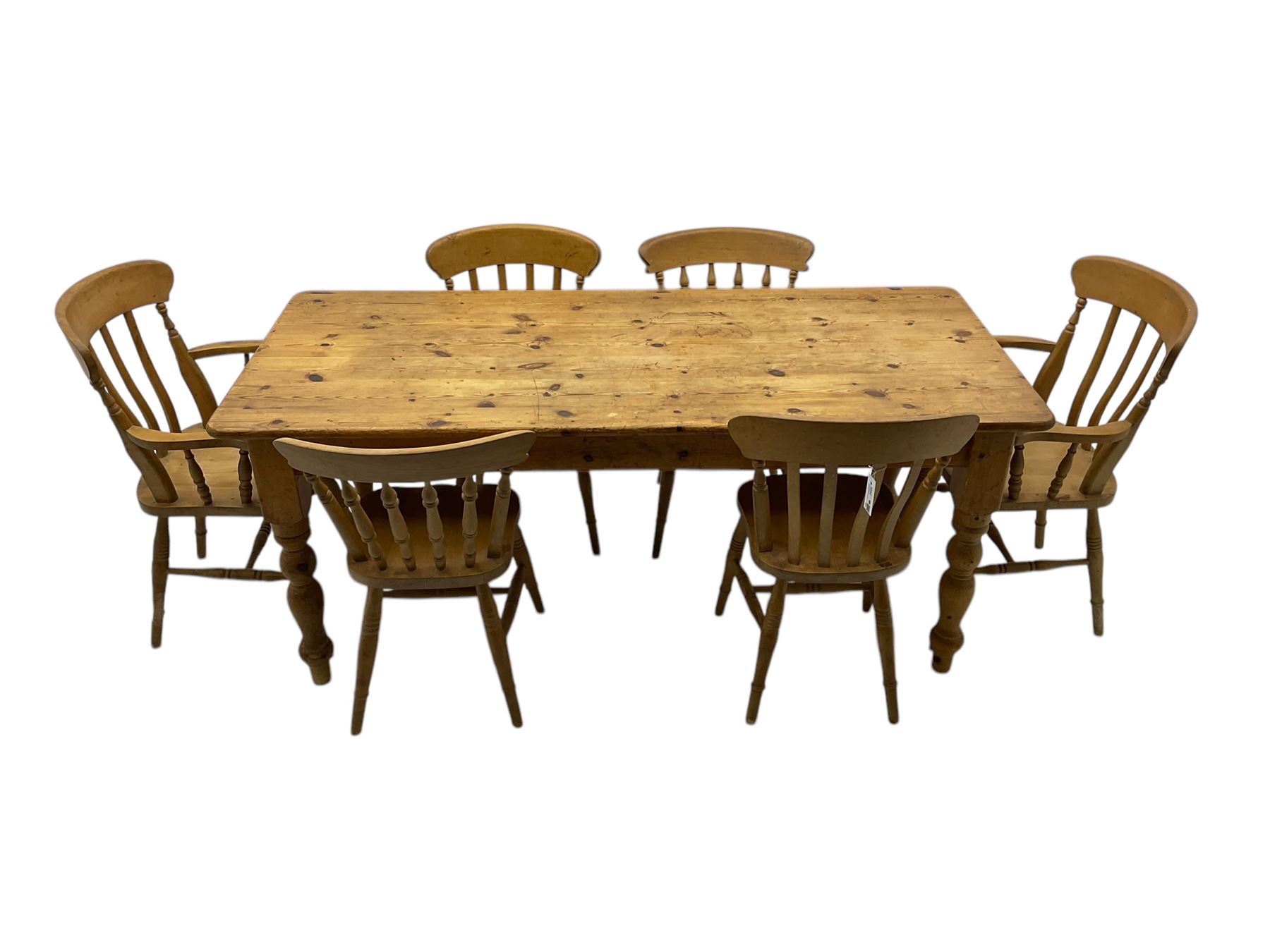 Pine farmhouse dining table, rectangular top with rounded corners, raised on turned supports; together with a set of six (4+2) spindle-back dining chairs
