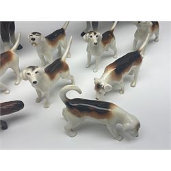 Beswick hunting group, comprising huntswoman on grey horse no 1730, huntsman on brown horse no 1501, fox figure no 1440 and eight fox hounds, all with printed marks beneath (11)