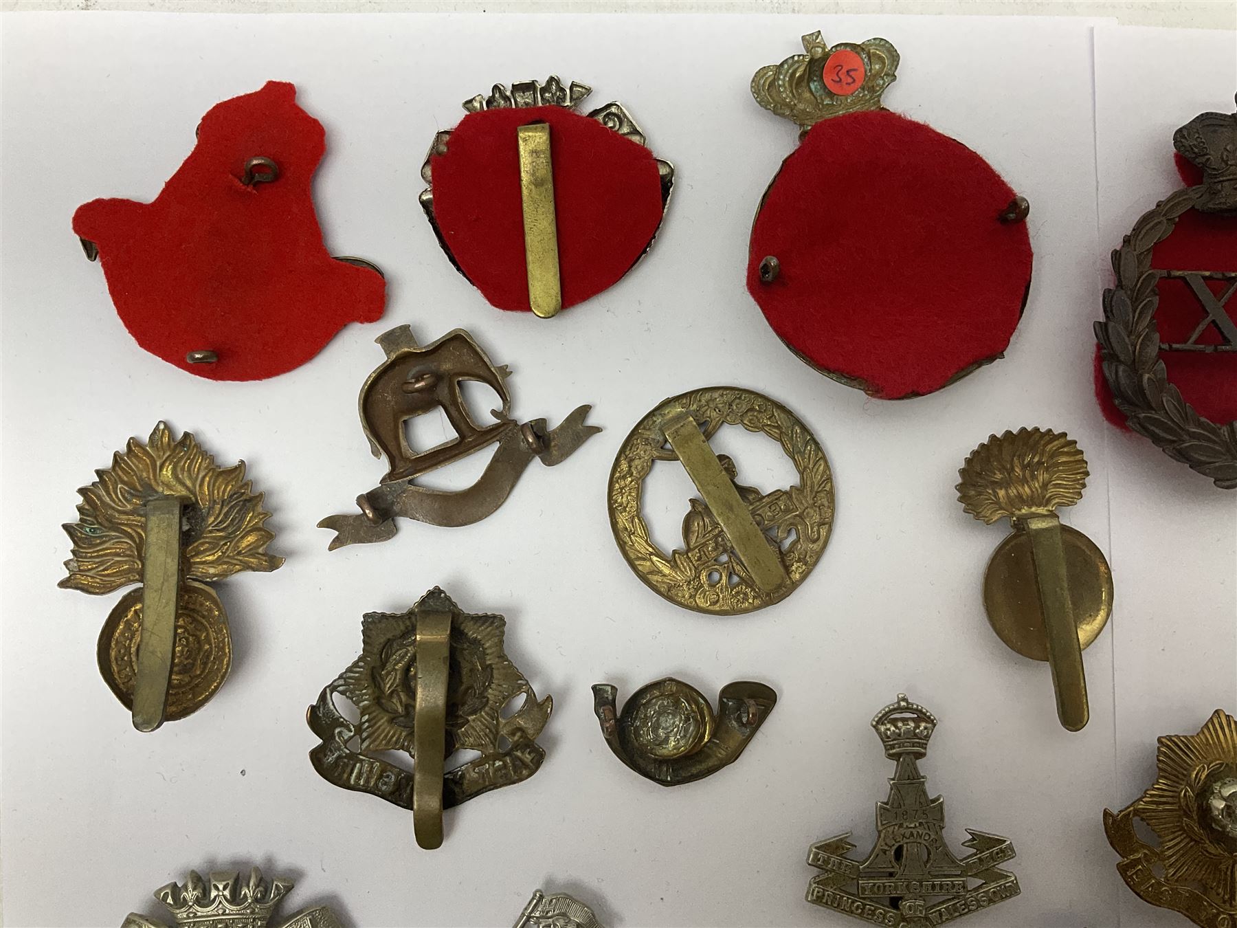 Over thirty regimental cap badges for fusiliers, Yorkshire interest, Light Infantry etc including Royal Scots and Welsh fusiliers, Durham L.I., KO Yorkshire L.I., Oxford & Bucks L.I., Green Howards, East Yorkshire, West Riding, York North Riding etc 