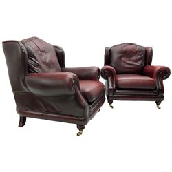 Thomas Lloyd - three-piece lounge suite, comprising of traditional shape two seat sofa (W190cm H80cm) and a pair of wingback armchairs (W100cm H91cm), each with rolled arms over turned supports with brass castors, upholstered in oxblood red leather