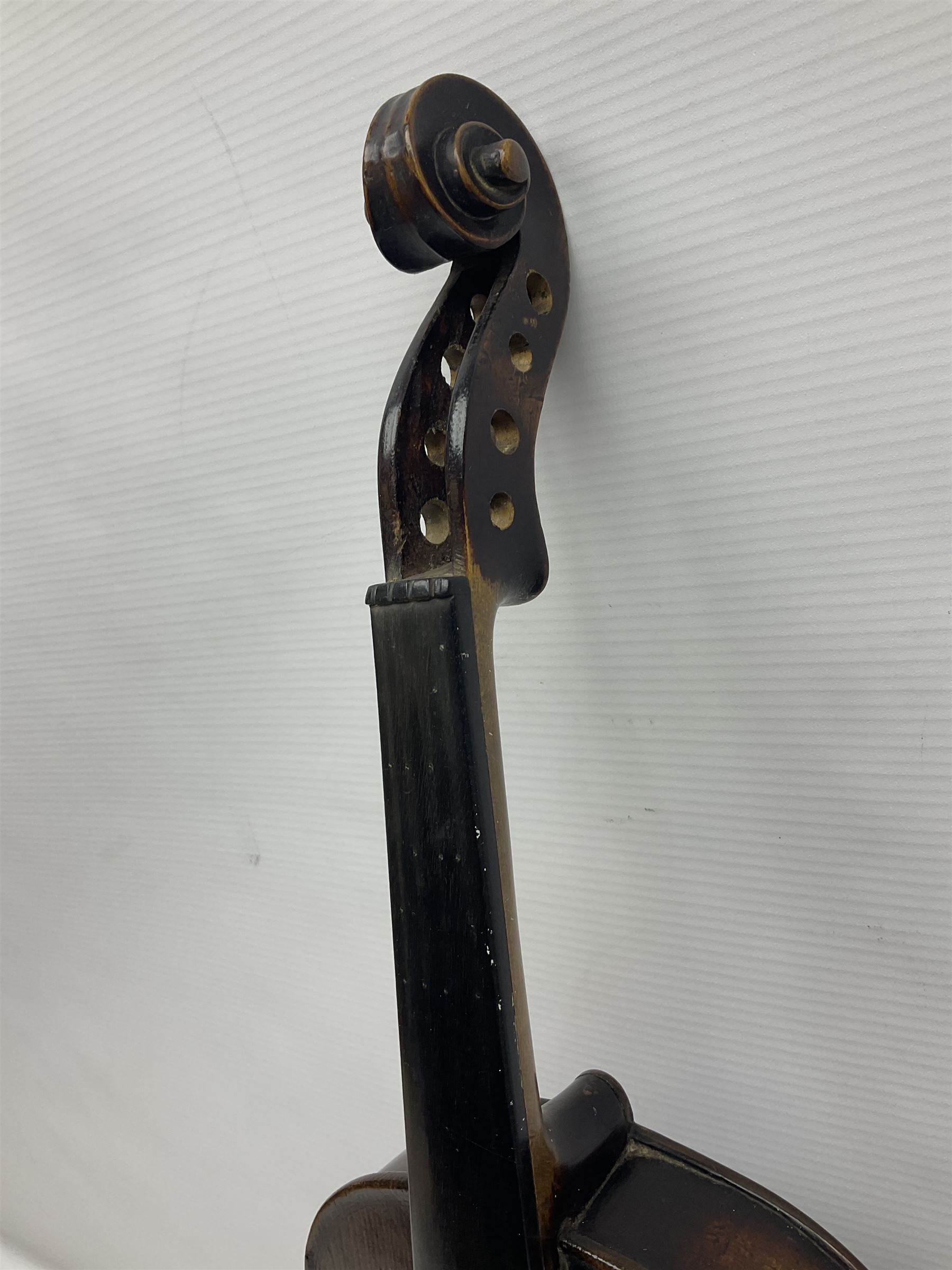 German violin c1890 with 36cm two-piece maple back and ribs and spruce top; bears label 'Antonius Stradivarius Cremona Faciebat Anno 1729' L59.5cm overall; in ebonised wooden 'coffin' case; and two German violins c1890 for completion - one bearing a Stradivarius label, the other a Ruggeri label; both in carrying cases (3)