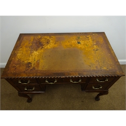  George lll style mahogany kneehole writing desk, gadroon carved top with inset brown leather writing surface, the five cockbeaded drawers with brass swan necked handles on shell carved cabriole legs with claw and ball feet, W106cm, D62cm, H76cm   