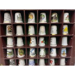 Collection of thimbles to include two stamped silver examples, other ceramic and metal examples etc housed in two glazed cabinets 
