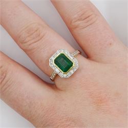 18ct gold emerald and diamond cluster ring, octagonal cut emerald of approx 1.50 carat, with milgrain set, round brilliant and baguette cut diamond surround and diamond set shoulders, stamped 750, total diamond weight approx 0.45 carat