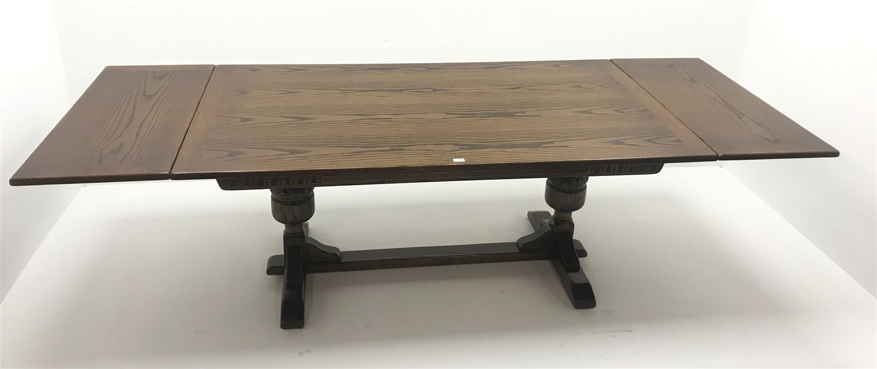  Old Charm oak drawer leaf dining table, carved cup and cover supports on shaped sledge feet joined by single stretcher (W275cm extended, 183cm closed, H76cm, D108cm) and set eight (6+2)  chairs, arched cresting rail with finials, studded leather back and seat, cup and cover supports joined by stretchers (W  