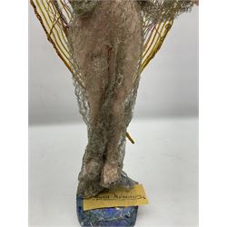 Anna Meszaros Hungary - hand made needlework figurine of an Angel with metallic lace full length dress and open threadwork wings; on moulded base H45cm Auctioneer's Note: Anna Meszaros came to England from her native Hungary in 1959 to marry an English businessman she met while demonstrating her art at the 1958 Brussels Exhibition. Shortly before she left for England she was awarded the title of Folk Artist Master by the Hungarian Government. Anna was a gifted painter of mainly portraits and sculptress before starting to make her figurines which are completely hand made and unique, each with a character and expression of its own. The hands, feet and face are sculptured by layering the material and pulling the features into place with needle and thread. She died in Hull in 1998.