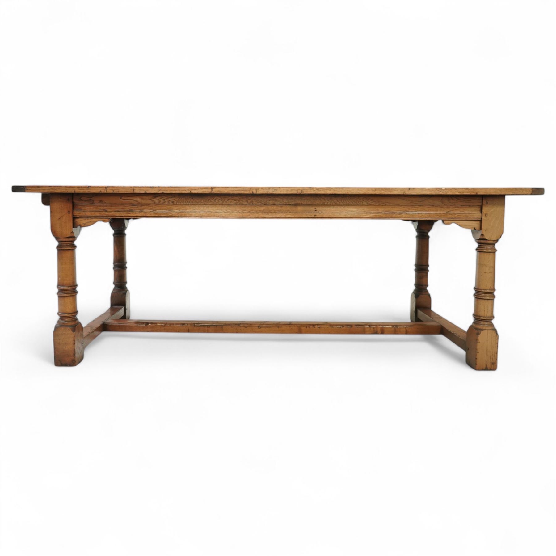 Late 20th century oak refectory table in 17th century style, with plank top and end leaf, raised on ring turned baluster legs with square feet, joined by conforming stretchers (260 cm extended)