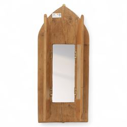 Rustic pine wall mirror, lancet arched frame with hinged shutter doors enclosing rectangul...