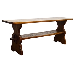  'Gnomeman' oak coffee table, narrow rectangular adzed top, shaped end supports joined by pegged under tier, by Thomas Whittaker of Little Beck, W123cm, H46cm, D31cm  