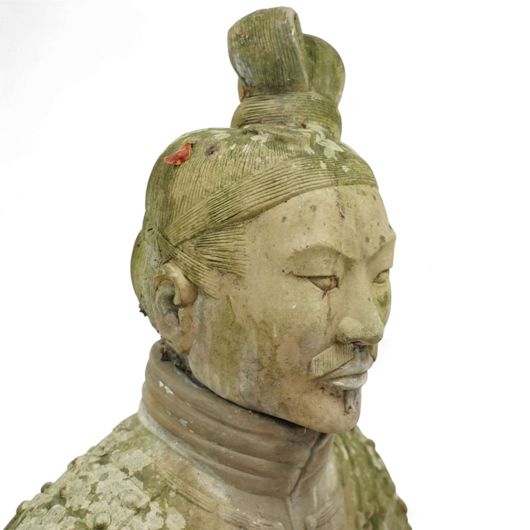 Two near life-size terracotta warrior figures, modelled in the style of the Qin dynasty soldiers, each kneeling with one arm raised, wearing detailed armour and tunics, one example partially damaged and lacking sections