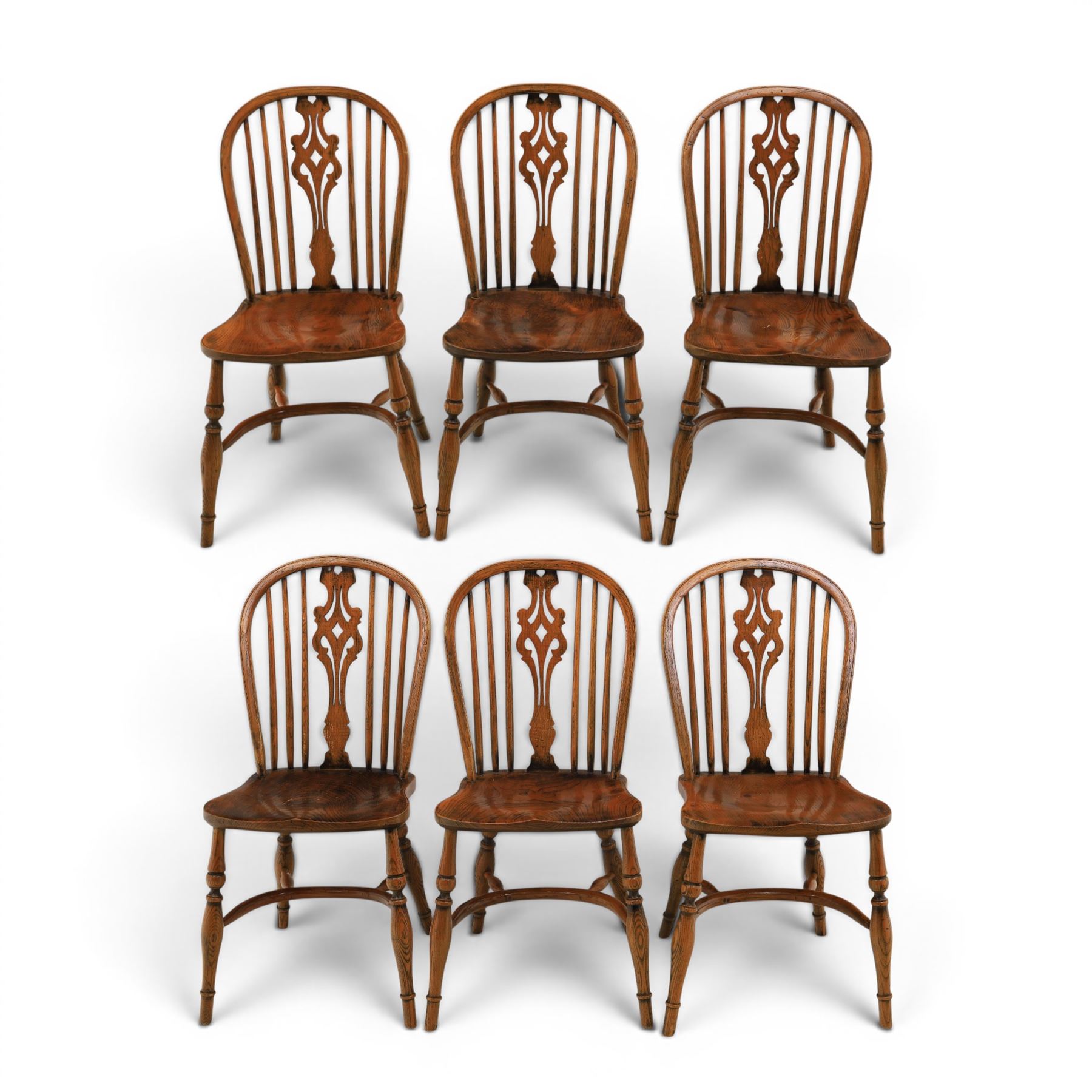 Set of six elm Windsor chairs, saddle seats with crinoline stretchers