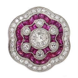  Large platinum (tested) ruby and diamond flower head ring, with diamond shoulders  
