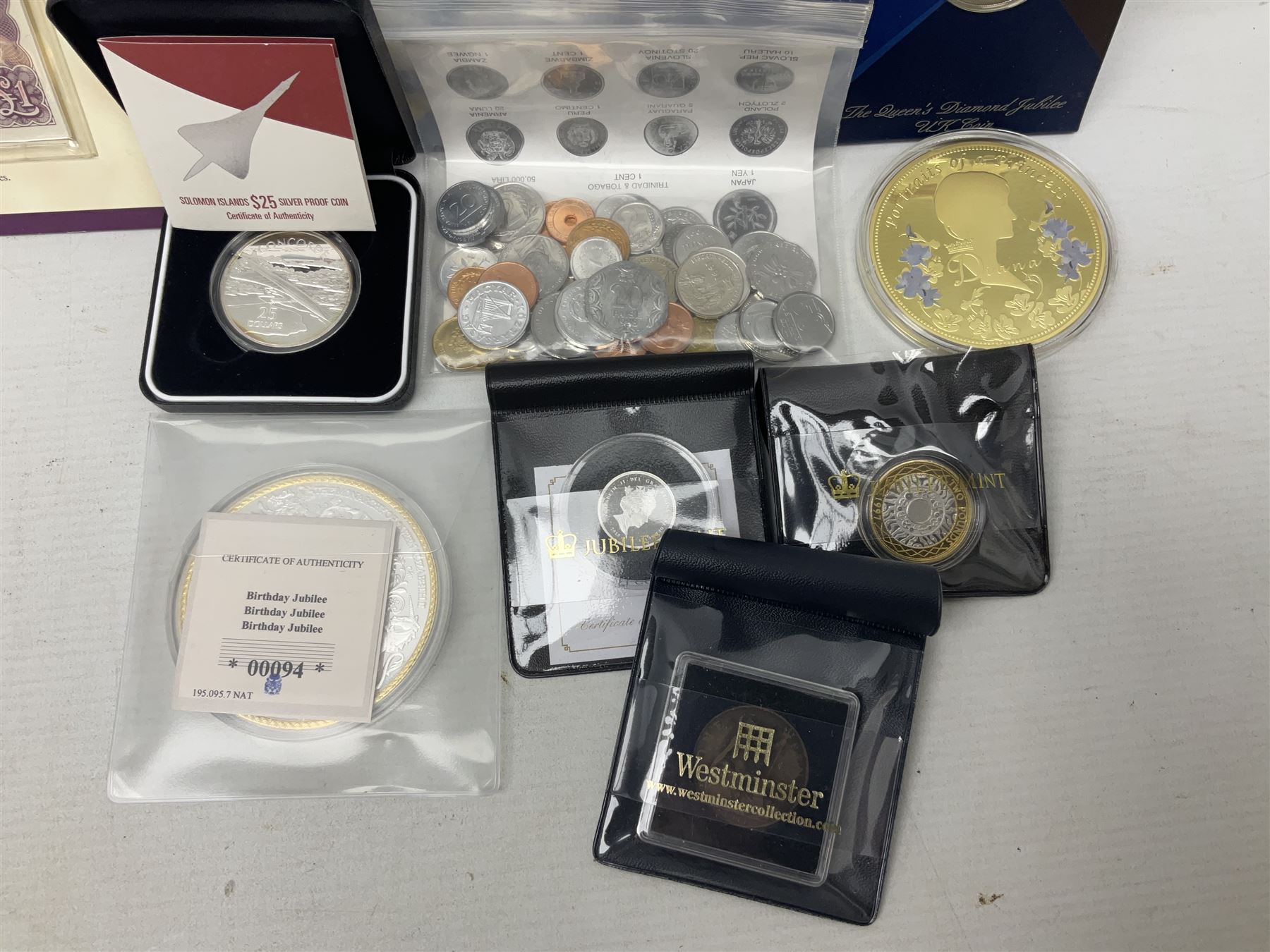 Coins and sets, including Great Britain and Northern Ireland 1970 proof coin collection in card folder, Queen Elizabeth II 2021 'Through the Looking Glass' five pounds, 2021 'Winnie the Pooh' fifty pence, Queen Victoria 1887 halfcrown, King George V 1914 halfcrown, commemorative coins, The Royal Mint Solomon Islands 2003 twenty-five dollars silver proof coin cased with certificate, 9ct gold half sovereign mount etc