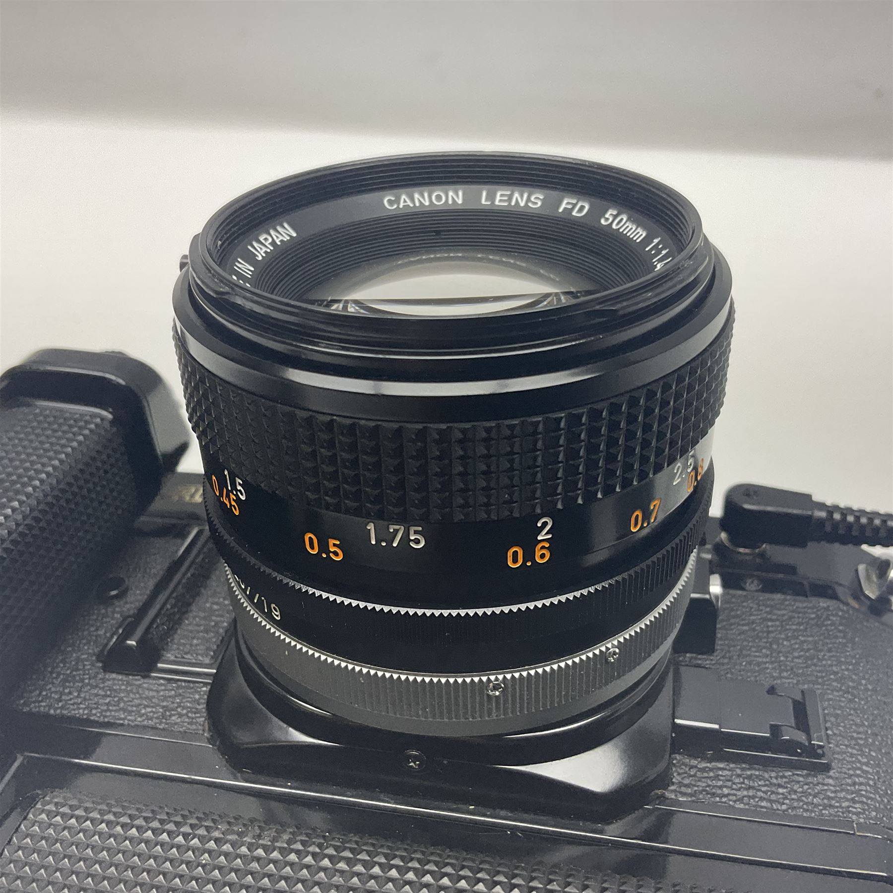 Canon A-1 camera body, serial no. 341014, with 'Canon FD 50mm 1:1.4 S.S.C.' lens, serial no. 12077119 and motor drive MA