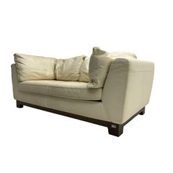 Roche-Bobois - two seat sofa, upholstered in ivory leather with buttoned seat cushions, raised on a stained beech base with bracket feet