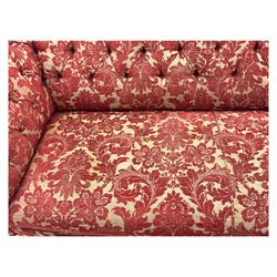 Late 20th century upholstered Chesterfield sofa, in red damask floral fabric, with deep buttoned back and arms, scrolled arms at equal height to back, on turned front supports