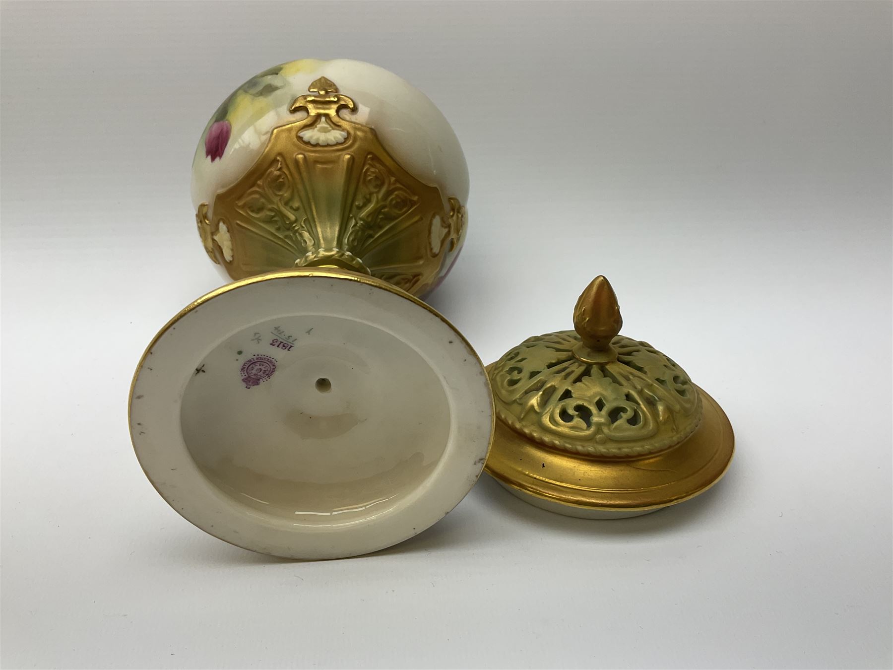 A Royal Worcester potpourri vase and cover, shape 1813, the bulbous body hand painted with pink roses and signed A Watkins, supporting a gilded and burnished pierced cover, upon a moulded stem with zoomorphic mask detail and circular foot, with puce printed mark beneath, H24cm