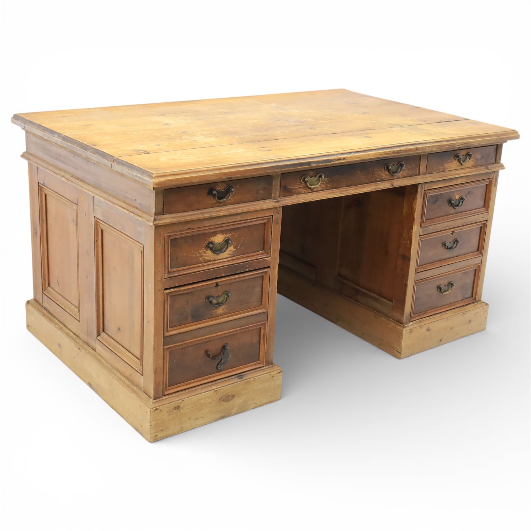 Late 19th century Victorian pine twin pedestal desk, rectangular plank top above an arrangement of seven drawers with brass swan neck handles, each pedestal fitted with one drawer above a double height drawer, raised on plinth bases with panelled sides